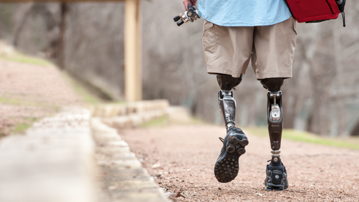 Aaron Holm walking wearing bilateral Genium knees