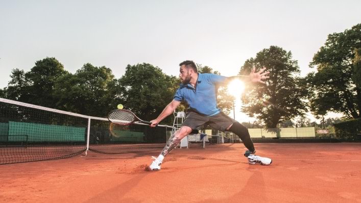 man playing tennis with Challenger foot
