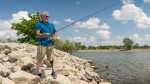 Steve fishing on a lakeshore while wearing his Harmony prosthesis