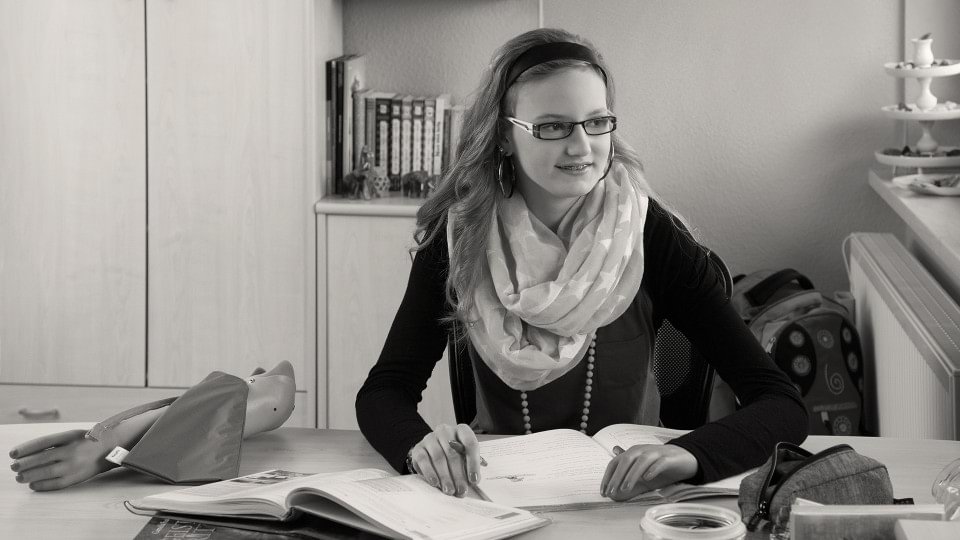 Antonia doing schoolwork with Electrohand